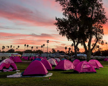 Pink sleeping tents in field